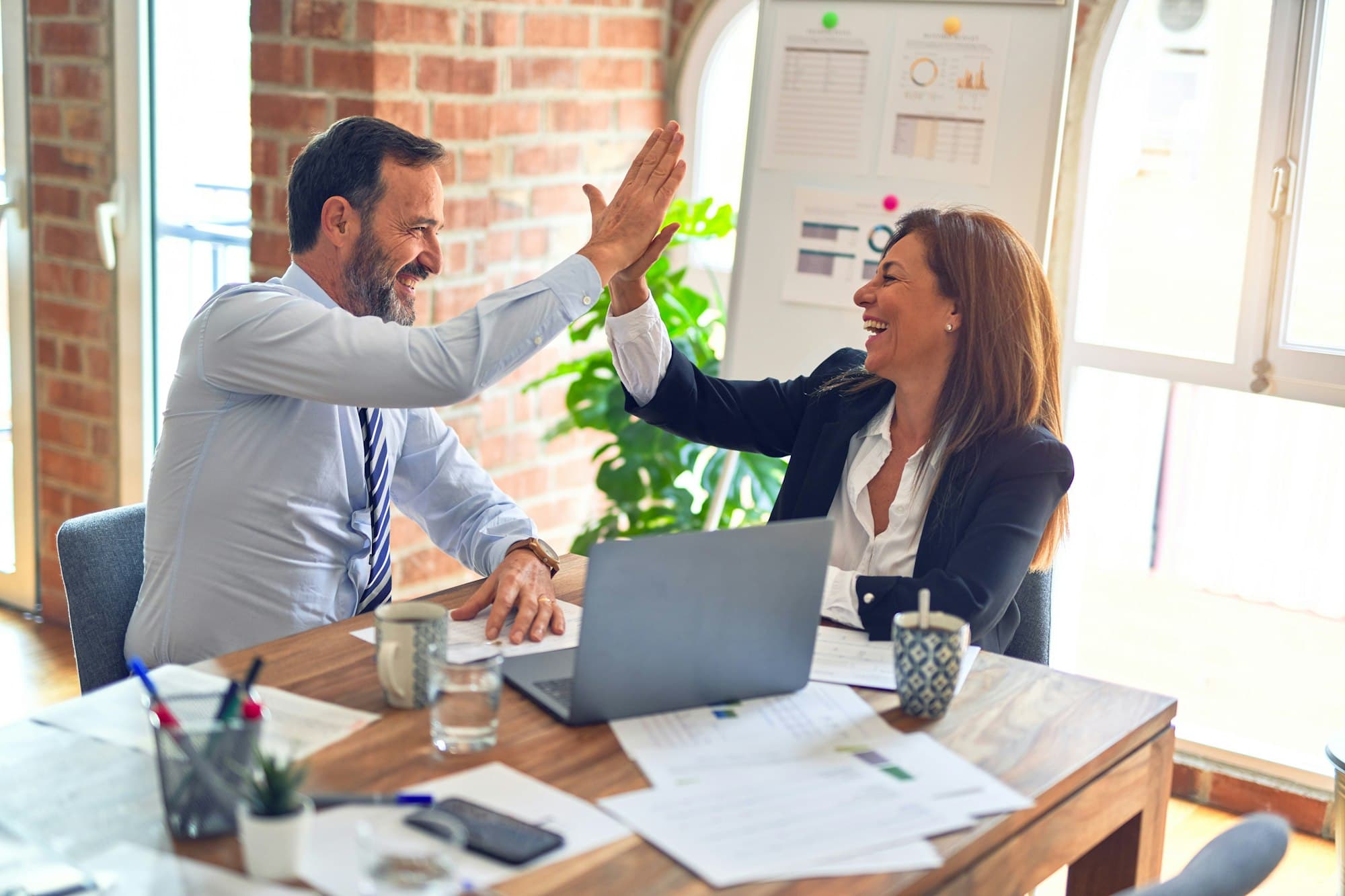 Accountant and small business client reviewing financial reports